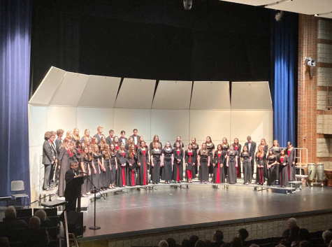 Choir director, Mr. Wand, honors some choir students for their achievements so far within the school year.  