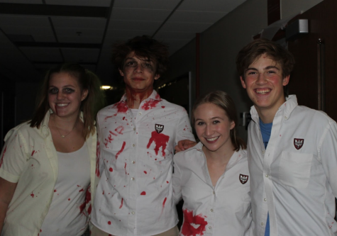 Sophomores (left to right) Kiki Sobkowiak, Jeffrey Lange, Gwen Heimburger, and  Johnny O’Connor line St. Josephs Hall to scare guests. 