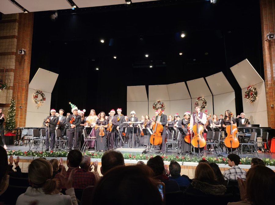 Members+of+Orchestra+and+Band+stand+when+the+audience+applauds+them+for+their+performance.
