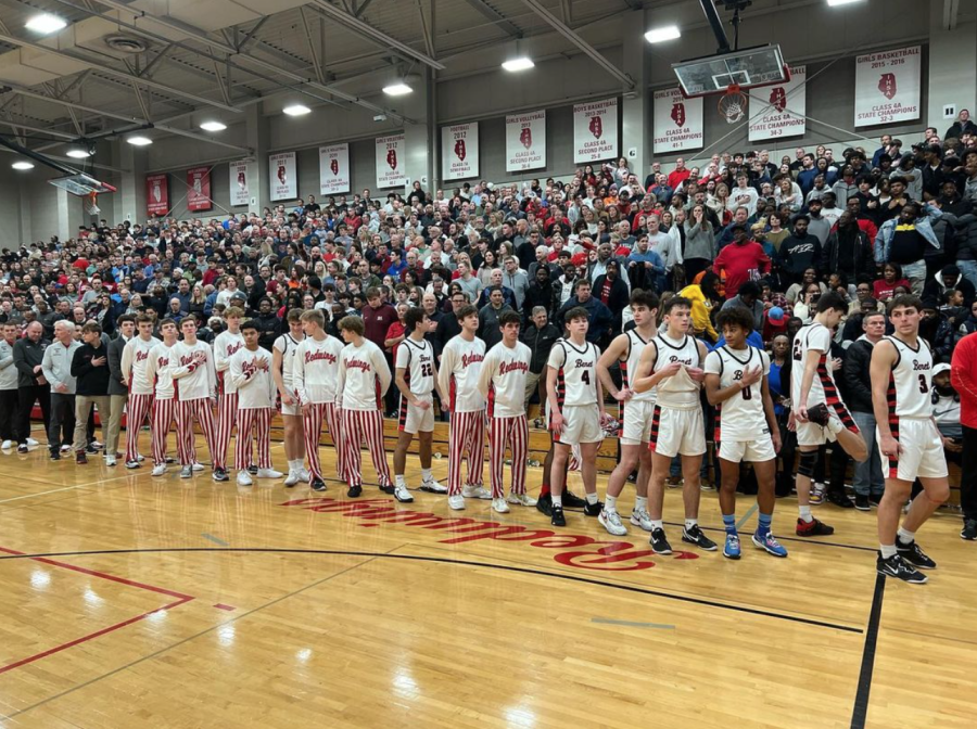 The Benet Academy boys basketball team line up before the start of their basketball game against Kenwood Academy.