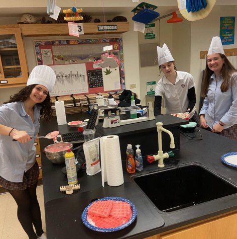 Members of the Environmental Club help cook pancakes to raise money for their club.