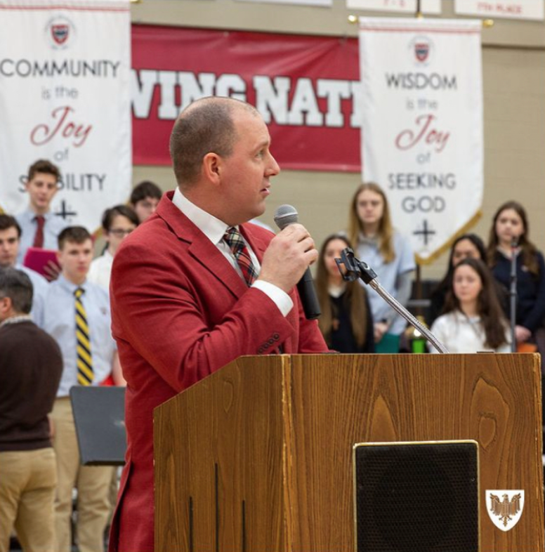 Principal Myers speaking during the all school mass for the passing of St. Benedict after the Junior Ring Ceremony.
