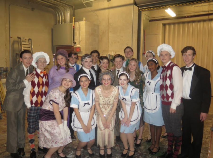 A few cast members of The Drowsy Chaperone poses for a group picture backstage. 