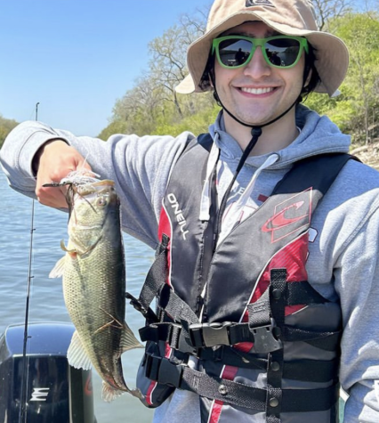 Senior Harrison Bavone holds up a fish at the IHSA Bass Fishing Sectionals. 