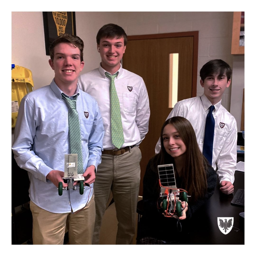Students pose with a project they made during an engineering class at Benet Academy.