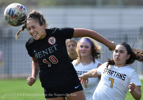 Courtesy of the Naperville Sun. Sophomore Johnna Caliendo heads the ball away from Marian Catholic.