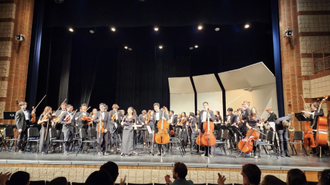 Benet Academy students bow after the Spring Band and Orchestra Concert