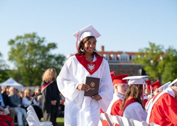 A Benet student stands up out of her seat during the 2024 Graduation Ceremony (Note: this article was originally published without a photograph).