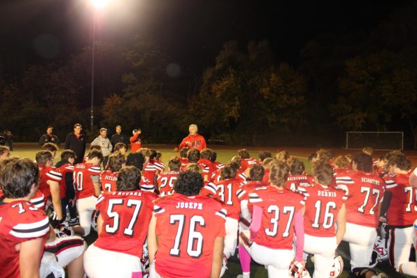 Benet Football Coach Patrick New gives his football players a pep talk after beating DePaul College Prep, clinching both a guaranteed IHSA Playoff Berth and the CCL/ESCC Division Championship in the process.