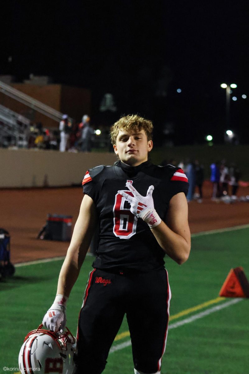 Football player Dan Flores celebrates the teams victories at its home field, Benedictine University Stadium, which is across the street from Benet Academy. The Redwings went 4 - 1 during home football games this season, with the only loss coming to Fenwick, a top team in Class 7A, two levels above Benet.