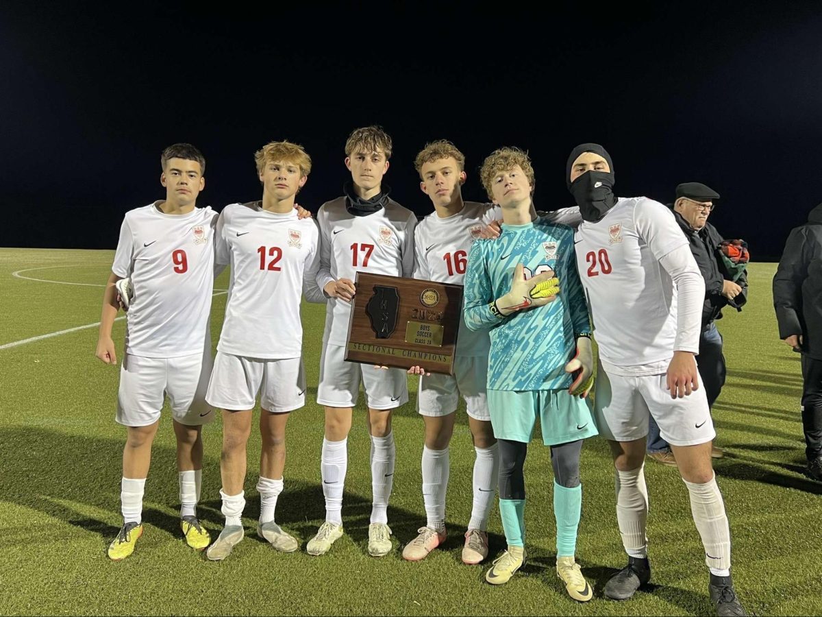 The Juniors huddled up with the Sectional Camps plaque after beating Wheaton Academy.