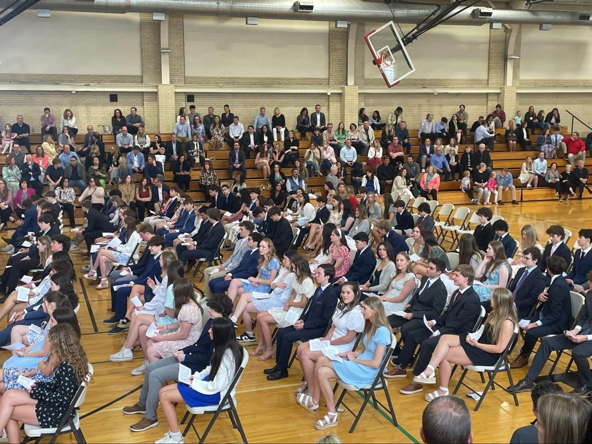 New inductees, as well as parents in the bleachers, wait to hear their names called to be inducted into Benet’s National Honor Society.